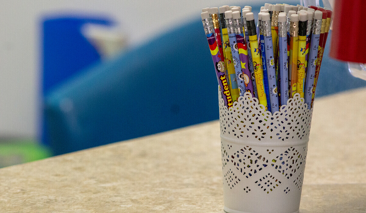 colourful pencils with white eraser tops in a fancy jar